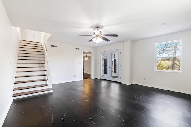 unfurnished living room featuring ceiling fan and french doors