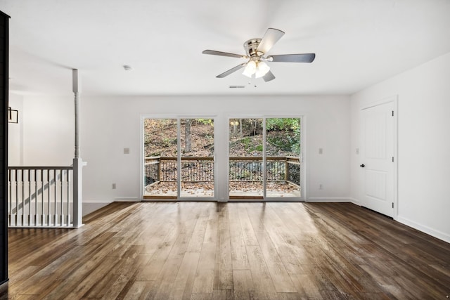 empty room with ceiling fan and dark wood-type flooring