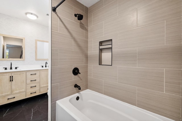 bathroom featuring vanity and tiled shower / bath combo