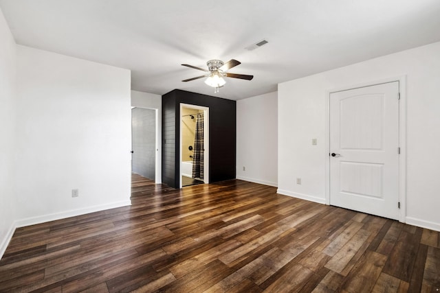 empty room featuring dark hardwood / wood-style flooring and ceiling fan