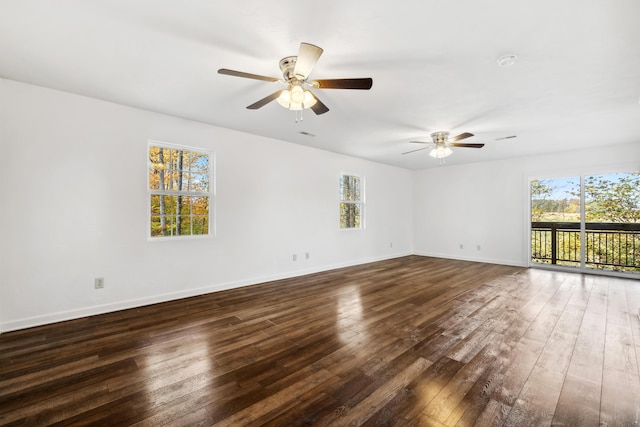 empty room featuring ceiling fan and dark wood-type flooring