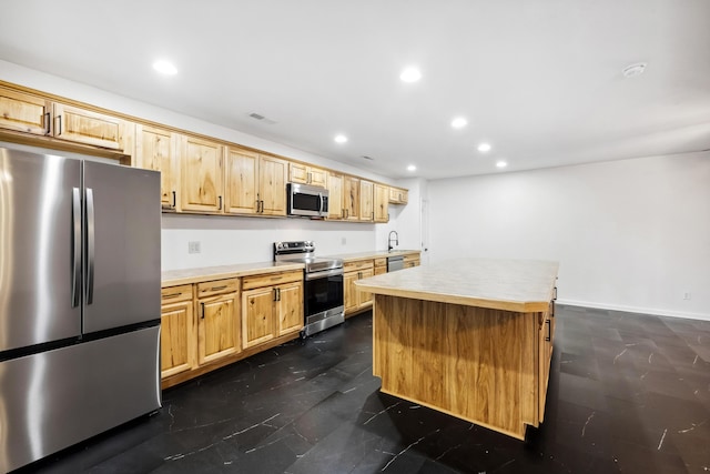 kitchen featuring a kitchen island, sink, and appliances with stainless steel finishes