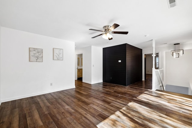 unfurnished living room featuring dark hardwood / wood-style flooring and ceiling fan