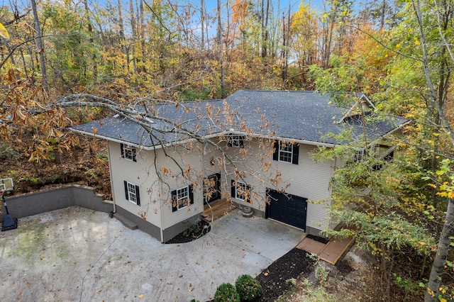 back of property featuring a garage