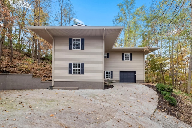 back of property featuring a garage