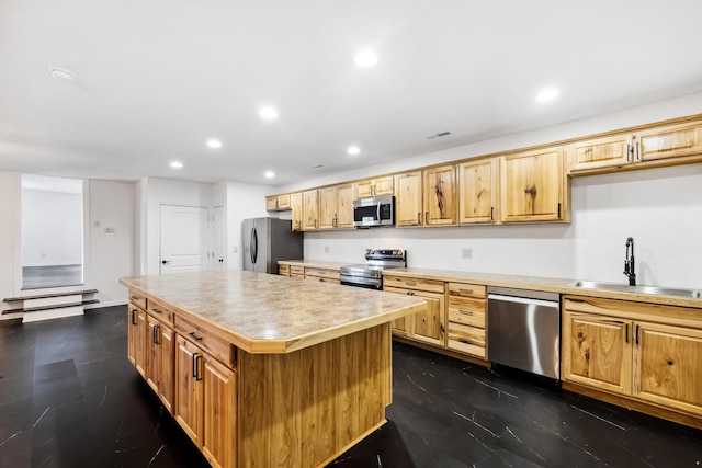 kitchen featuring a kitchen island, sink, and appliances with stainless steel finishes