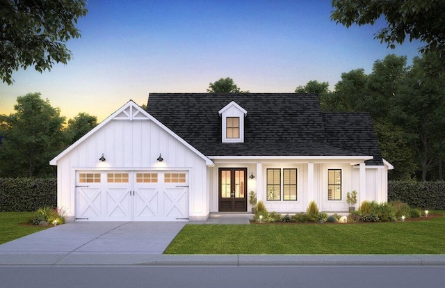 modern inspired farmhouse with french doors, board and batten siding, an attached garage, and a front yard