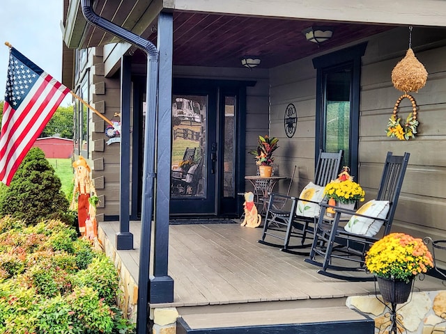 view of exterior entry featuring covered porch