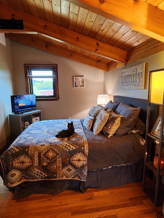 bedroom with hardwood / wood-style floors, lofted ceiling with beams, and wooden ceiling