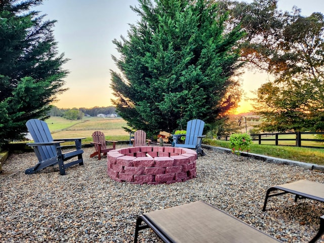 patio terrace at dusk featuring a fire pit