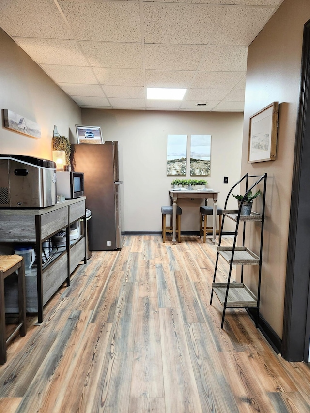 office featuring a drop ceiling and wood-type flooring