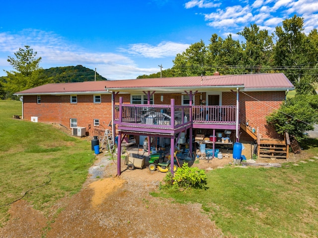 back of house featuring a yard and a wooden deck