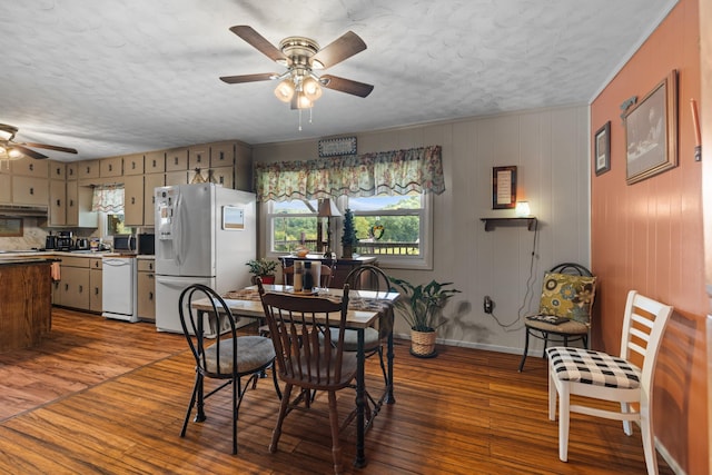 dining room featuring ceiling fan, dark hardwood / wood-style flooring, and a textured ceiling