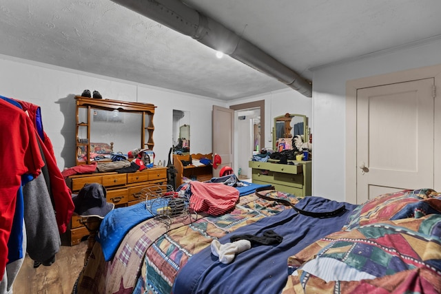 bedroom featuring wood-type flooring and a textured ceiling