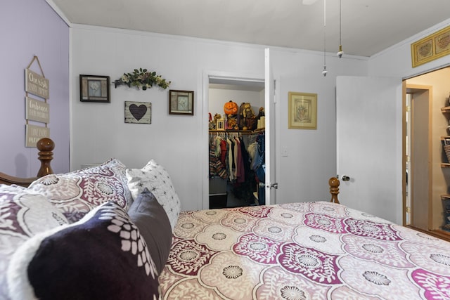 bedroom featuring crown molding and a closet