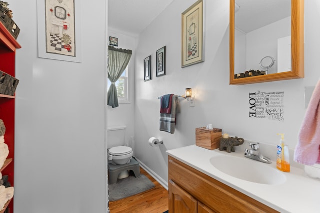 bathroom featuring hardwood / wood-style flooring, vanity, and toilet