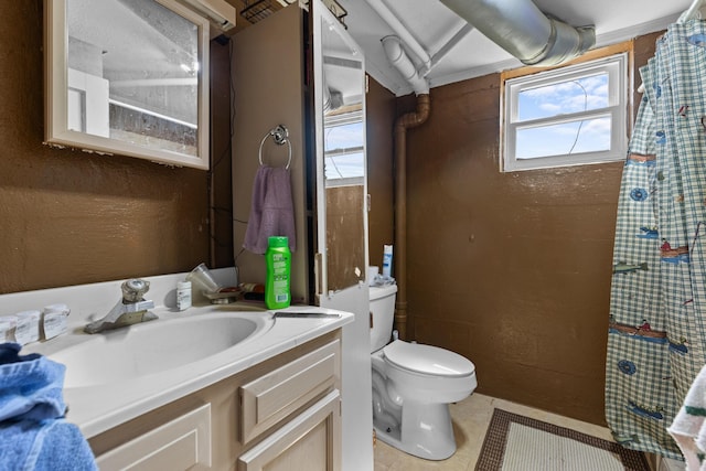 bathroom with tile patterned floors, curtained shower, vanity, and toilet