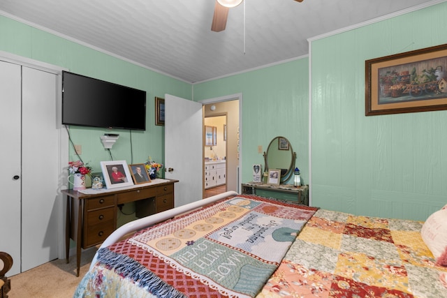 bedroom featuring carpet flooring, ensuite bath, ceiling fan, and crown molding