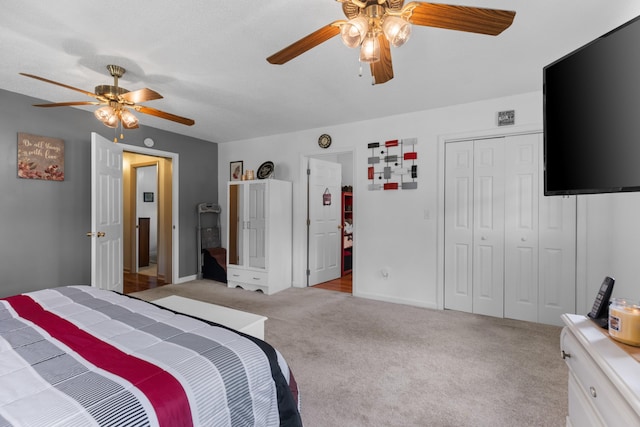 bedroom with ceiling fan, light carpet, and a closet