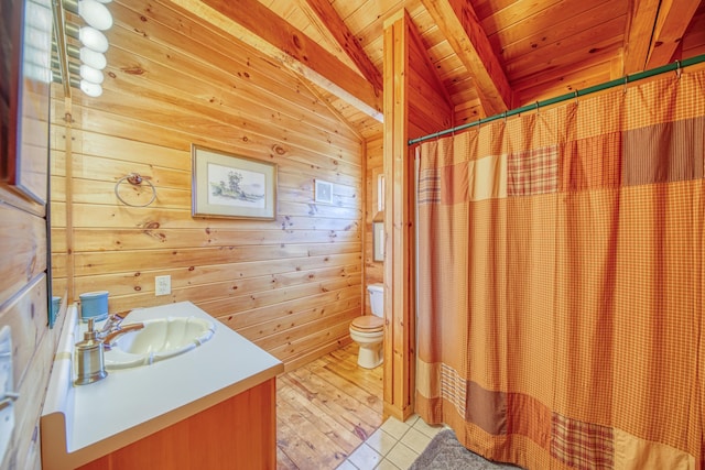 bathroom with wood ceiling, vanity, wooden walls, and vaulted ceiling with beams