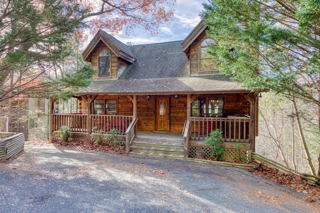 log-style house with a porch