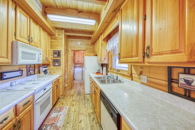 kitchen featuring sink, light hardwood / wood-style flooring, wooden walls, beamed ceiling, and white appliances