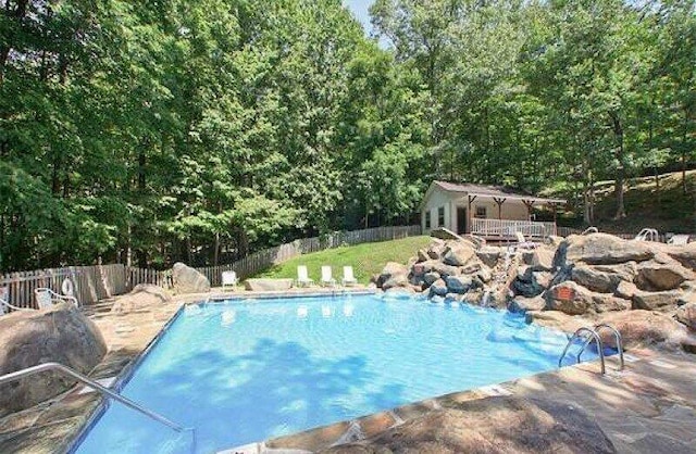 view of swimming pool with an outbuilding