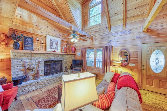 living room featuring a stone fireplace, wooden ceiling, wooden walls, and light hardwood / wood-style floors