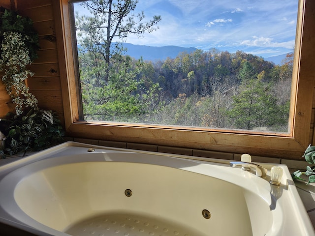 bathroom with a tub and a mountain view