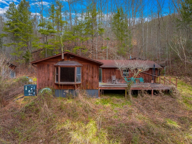 back of house with a wooden deck