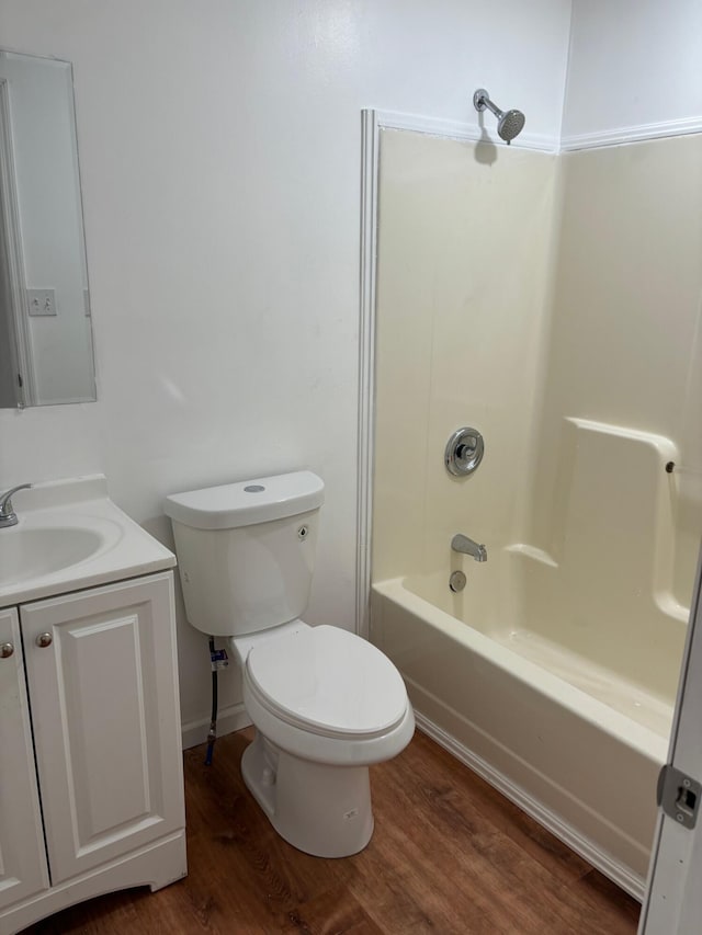 full bathroom with hardwood / wood-style flooring, vanity, toilet, and bathtub / shower combination