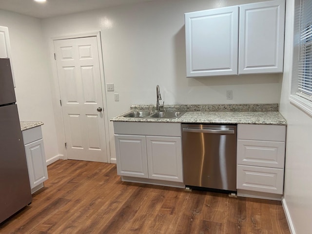 kitchen with sink, white cabinetry, stainless steel appliances, light stone countertops, and dark hardwood / wood-style flooring