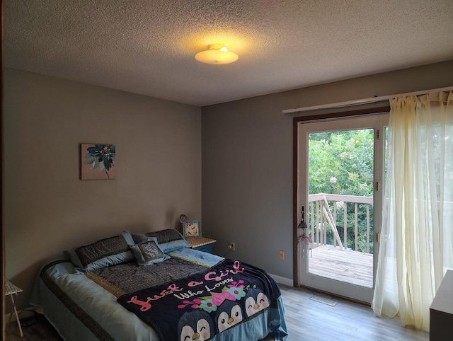 122 Shady Ln, Seymour, TN 37865 - bedroom featuring access to exterior, light wood-style flooring, and a textured ceiling
