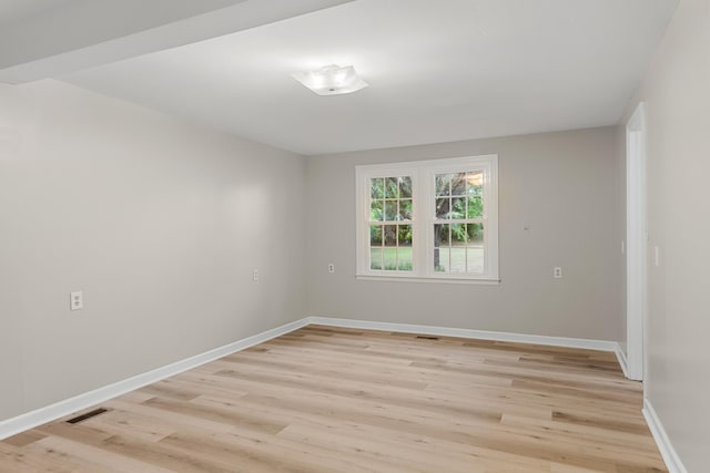 empty room with light hardwood / wood-style flooring