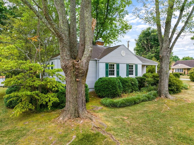 view of side of home featuring a lawn