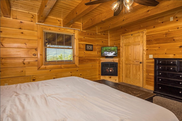 2040 Cougar Crossing Way, Sevierville, TN 37862 - bedroom featuring wood ceiling, wood walls, a warm lit fireplace, and beam ceiling