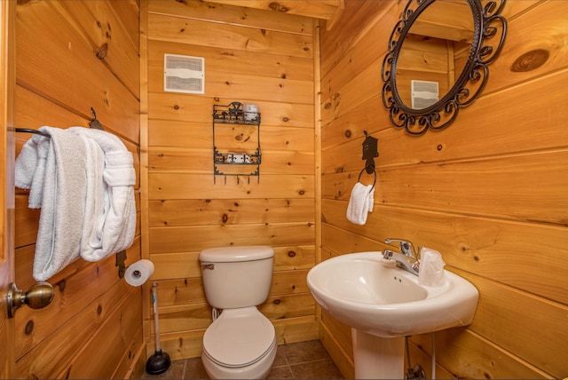 2040 Cougar Crossing Way, Sevierville, TN 37862 - bathroom with tile patterned flooring, wood walls, and toilet