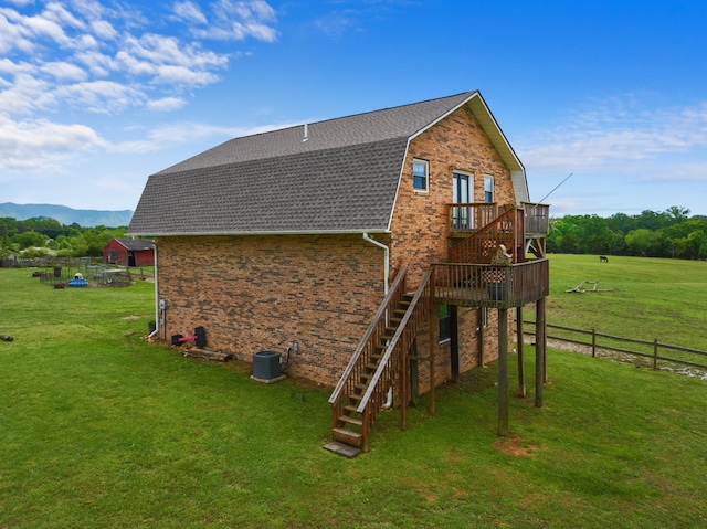 1439 Woods Ridge Rd, Dandridge, TN 37725 - view of side of home featuring stairway, a gambrel roof, roof with shingles, a deck with mountain view, and brick siding