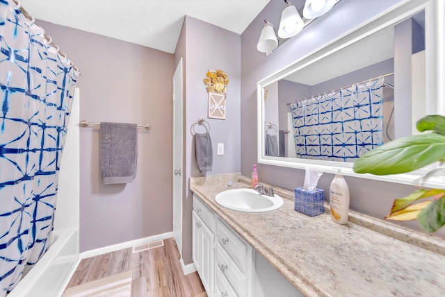 1439 Woods Ridge Rd, Dandridge, TN 37725 - full bathroom with vanity, wood finished floors, and shower / tub combo