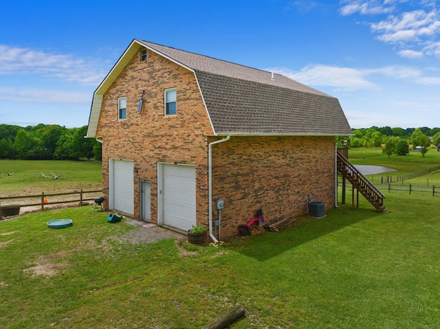 1439 Woods Ridge Rd, Dandridge, TN 37725 - view of home's exterior featuring a gambrel roof, a garage, a shingled roof, driveway, and brick siding