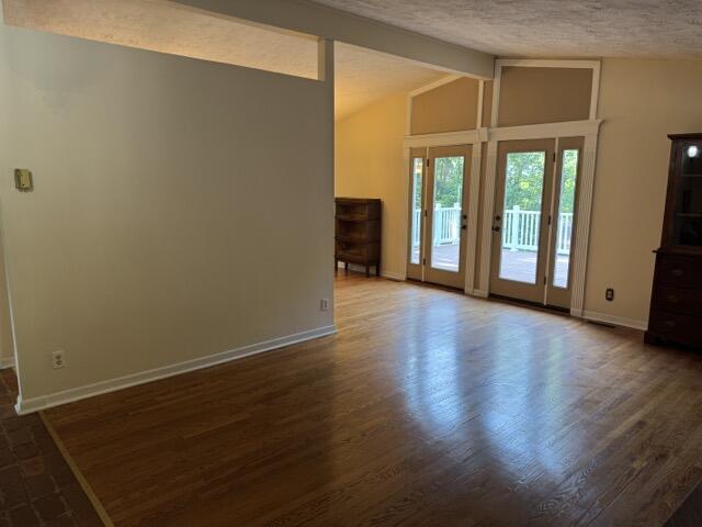 2414 Woodchuck Dell, Morristown, TN 37814 - unfurnished living room featuring dark wood finished floors and a textured ceiling