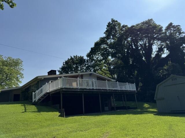 2414 Woodchuck Dell, Morristown, TN 37814 - back of property with a storage unit, a wooden deck, a yard, and stairway