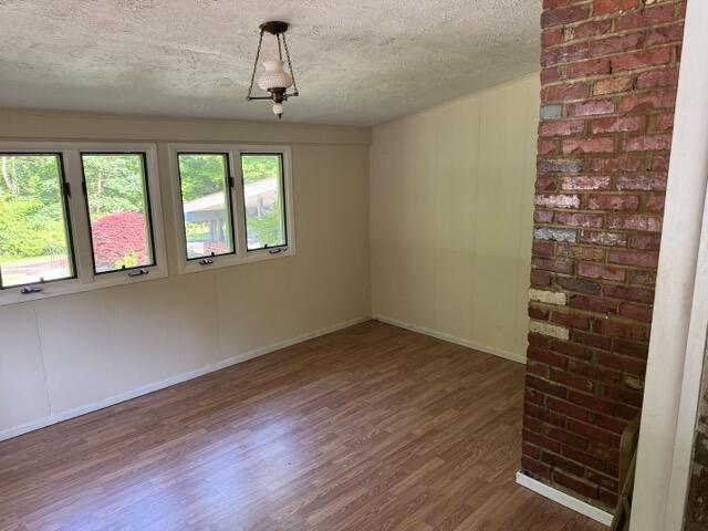 2414 Woodchuck Dell, Morristown, TN 37814 - empty room with wood finished floors and a textured ceiling