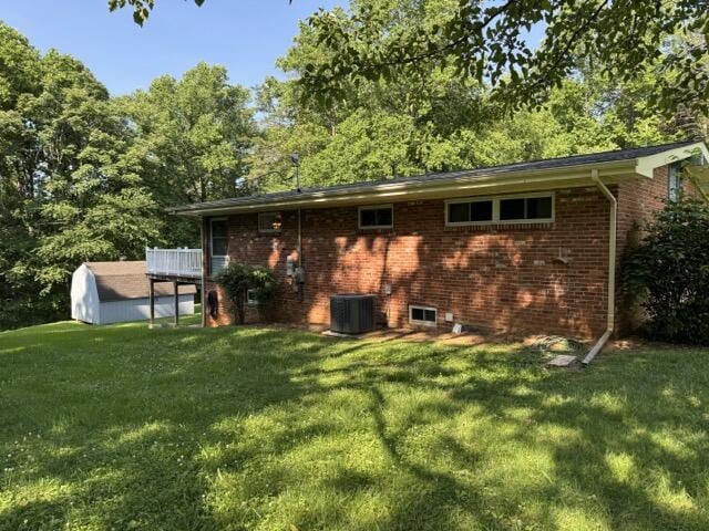 2414 Woodchuck Dell, Morristown, TN 37814 - rear view of house with a yard, brick siding, and a storage shed
