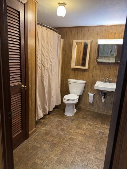 2414 Woodchuck Dell, Morristown, TN 37814 - full bath with brick patterned floors, wooden walls, and a shower with shower curtain