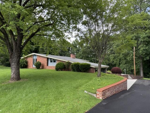 2414 Woodchuck Dell, Morristown, TN 37814 - ranch-style house featuring a chimney, a front lawn, and brick siding