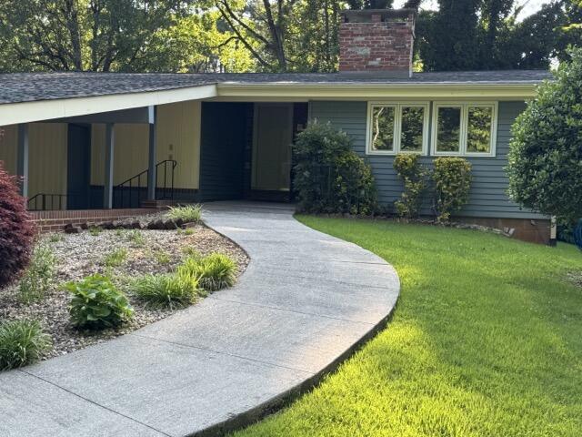 2414 Woodchuck Dell, Morristown, TN 37814 - view of front of house with a chimney and a front yard