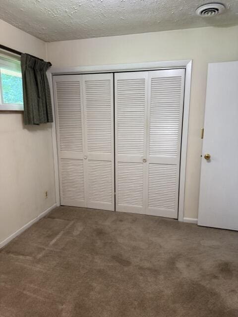 2414 Woodchuck Dell, Morristown, TN 37814 - unfurnished bedroom featuring carpet flooring, a closet, and a textured ceiling