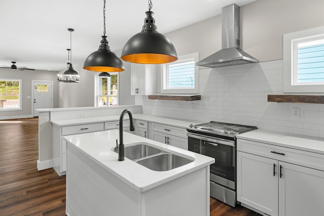 274A W Main St, Dandridge, TN 37725 - kitchen with wall chimney exhaust hood, stainless steel range with electric cooktop, a sink, a peninsula, and dark wood-style floors