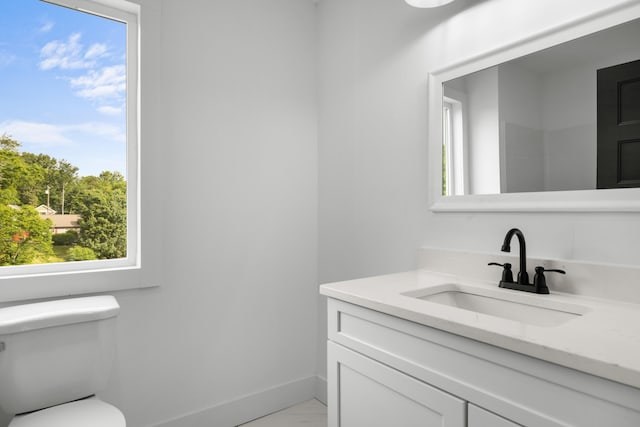 274A W Main St, Dandridge, TN 37725 - half bathroom with vanity, baseboards, toilet, and plenty of natural light
